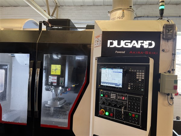 The Dugard 1100VMC running stainless steel parts at Dicker Precision
